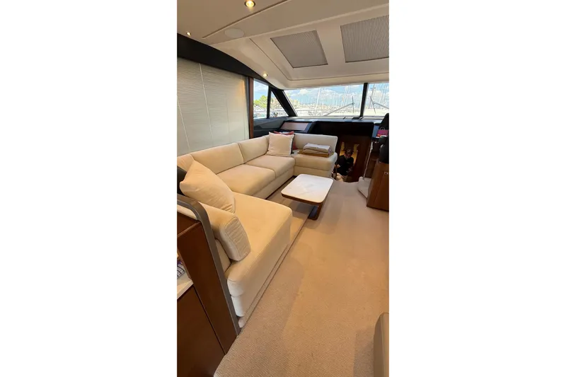 Three Amigos Yacht Photos Pics Luxurious interior of 2021 Princess S62 yacht with plush seating and modern design.