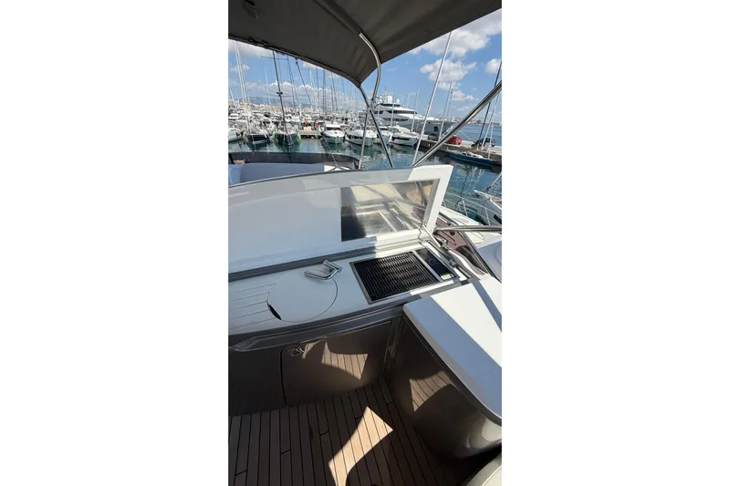 Three Amigos Yacht Photos Pics Outdoor kitchen on 2021 Princess S62 yacht, docked at marina under sunny skies.