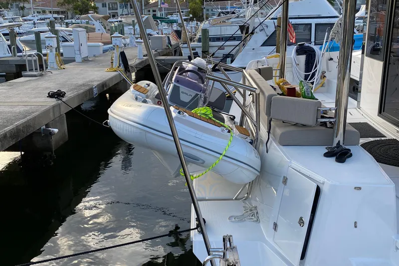 C Dreams Yacht Photos Pics Docked Bali 4.6 yacht with inflatable boat, 2022 model, in marina setting.