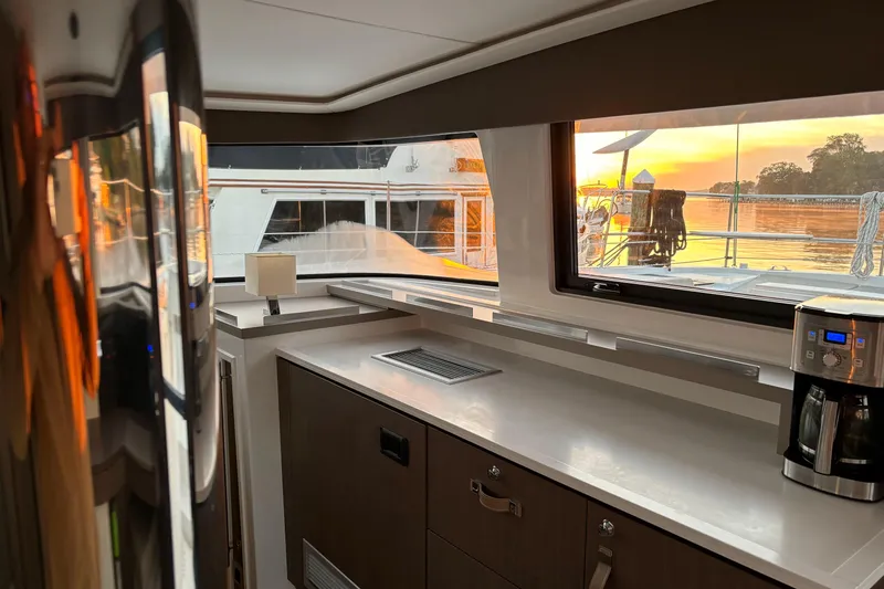 C Dreams Yacht Photos Pics Interior of 2022 Bali 4.6 yacht kitchen with sunset view through window.