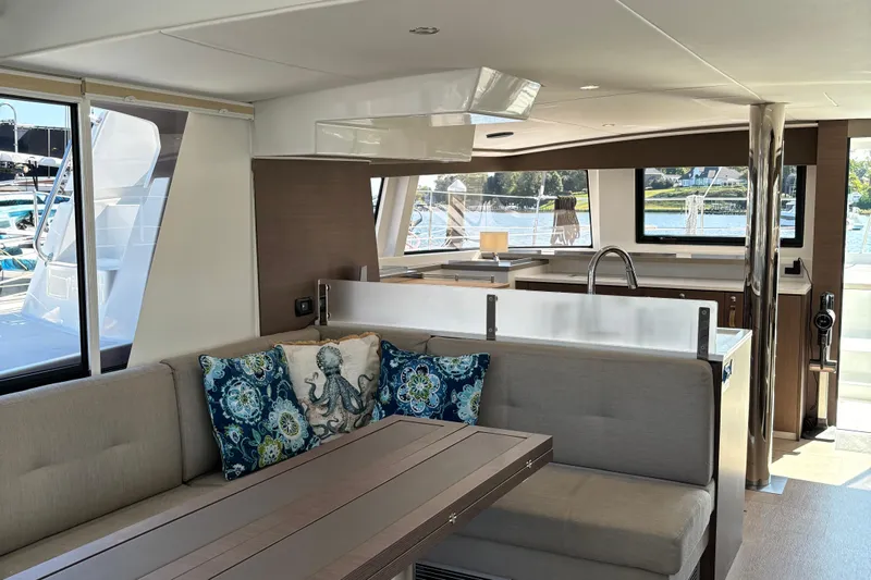 C Dreams Yacht Photos Pics Luxurious interior of 2022 Bali 4.6 yacht with modern kitchen and stylish seating area.