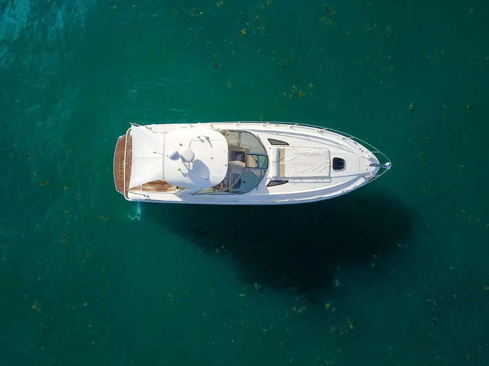  Yacht Photos Pics Aerial view of 2009 Sea Ray 350 Sundancer yacht on clear blue water.