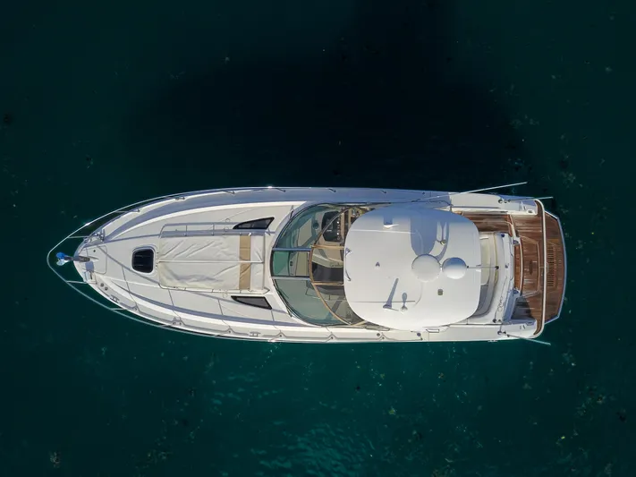  Yacht Photos Pics Aerial view of a 2009 Sea Ray 350 Sundancer yacht on clear blue water.