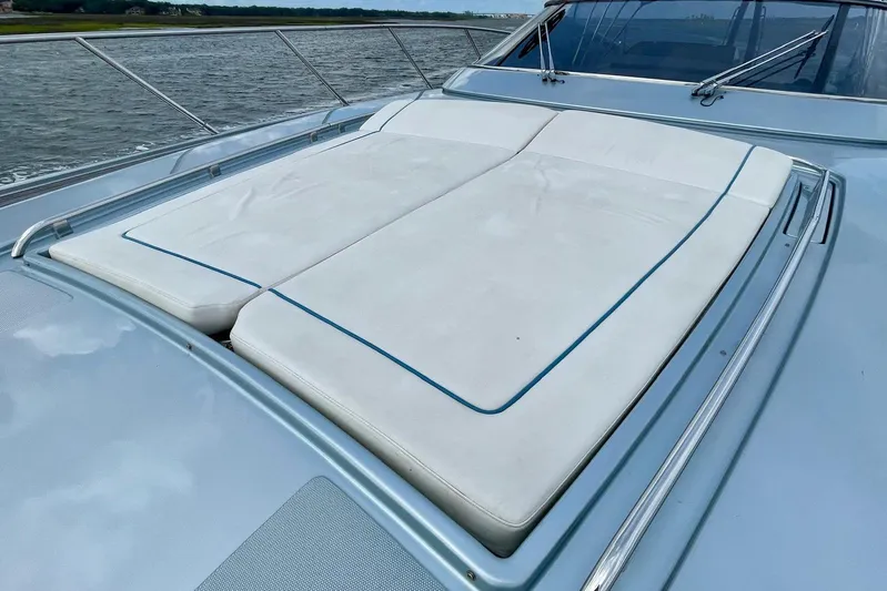 Andiamo Yacht Photos Pics 2016 Riva 63 Virtus yacht with spacious sunbathing deck, docked by the water.