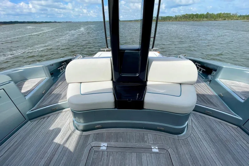 Andiamo Yacht Photos Pics 2016 Riva 63 Virtus yacht deck with white seating, cruising on open water.