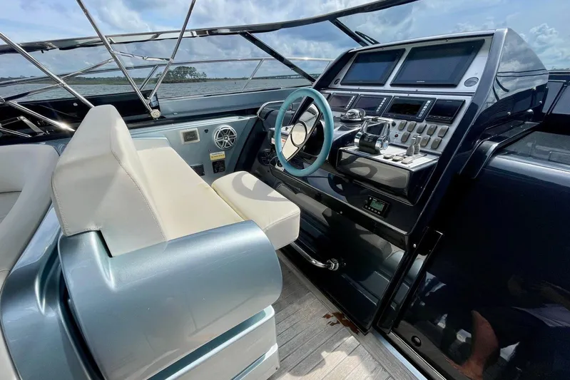 Andiamo Yacht Photos Pics 2016 Riva 63 Virtus yacht cockpit with modern controls and luxurious seating.