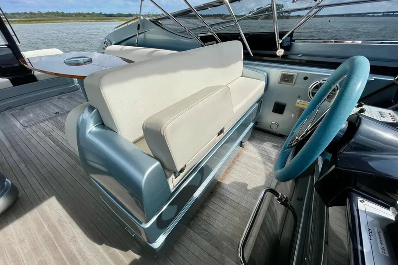 Andiamo Yacht Photos Pics Interior of 2016 Riva 63 Virtus yacht with steering wheel and seating area.