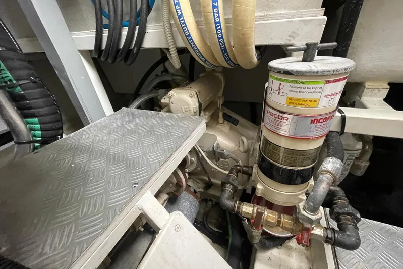 Andiamo Yacht Photos Pics Engine room of 2016 Riva 63 Virtus yacht, featuring mechanical components and hoses.