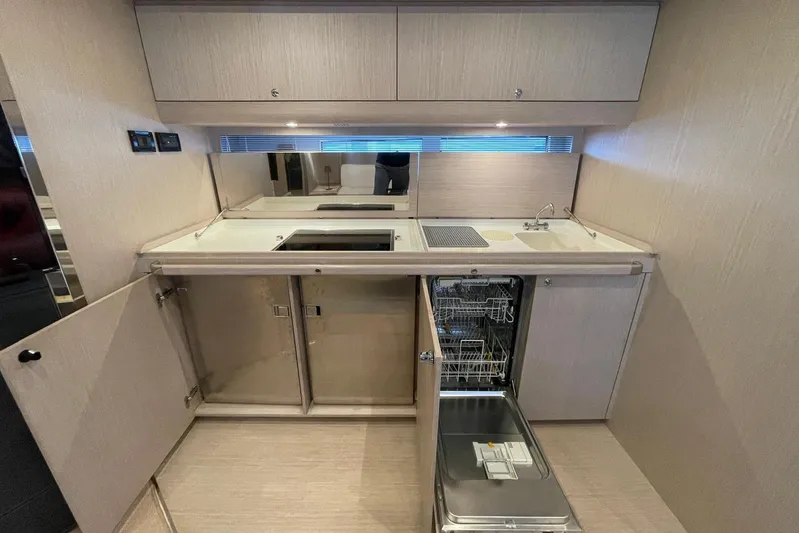 Andiamo Yacht Photos Pics Modern kitchen interior of 2016 Riva 63 Virtus yacht with sleek cabinetry and appliances.