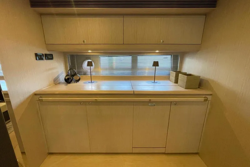 Andiamo Yacht Photos Pics Luxurious interior of 2016 Riva 63 Virtus yacht with elegant wooden cabinetry and modern decor.