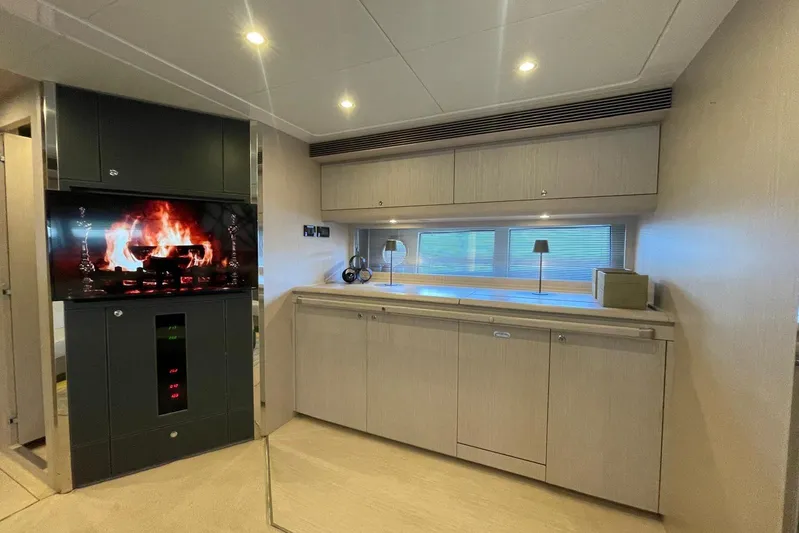 Andiamo Yacht Photos Pics Luxurious interior of 2016 Riva 63 Virtus yacht with modern fireplace and sleek cabinetry.