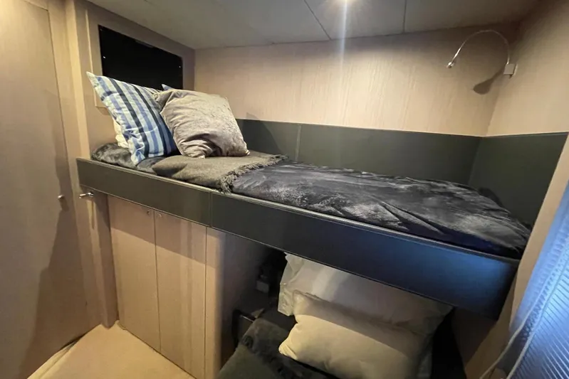 Andiamo Yacht Photos Pics Cozy cabin interior of 2016 Riva 63 Virtus yacht with bunk bed and pillows.