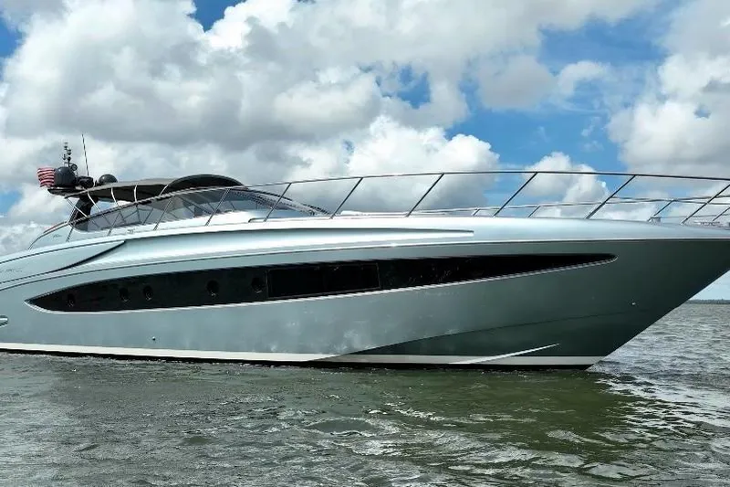 Andiamo Yacht Photos Pics 2016 Riva 63 Virtus yacht cruising on open water under a cloudy sky.
