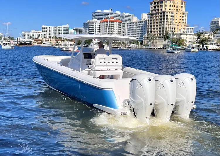 Talan't Show Yacht Photos Pics 2021 Intrepid 407 Nomad FE boat cruising in a city harbor.