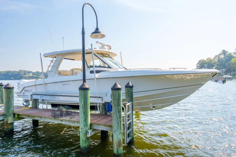 Cruzan Time Yacht Photos Pics 2018 Boston Whaler 350 Realm docked on a sunny day by the water.