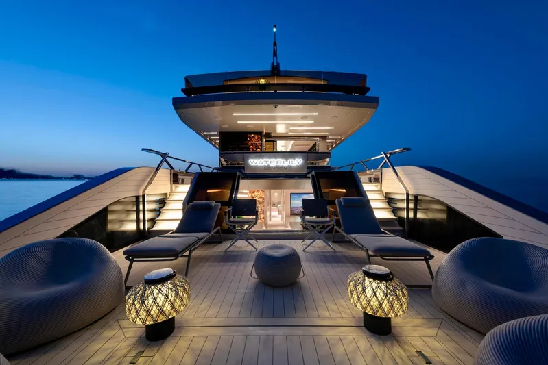  Yacht Photos Pics Luxurious 2025 Mazu Yachts 92 DS deck at sunset, featuring elegant seating and ambient lighting.