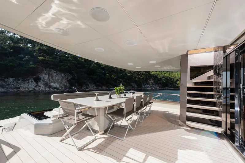  Yacht Photos Pics Luxurious deck of 2025 Mazu Yachts 92 DS with elegant dining area and scenic view.
