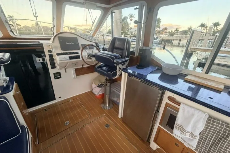 Miracle 2 Yacht Photos Pics Interior of 2006 True North 38 boat with helm, seating, and kitchenette.