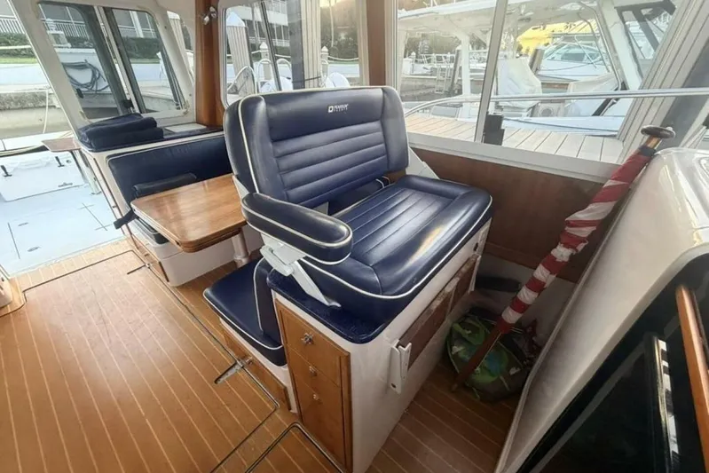 Miracle 2 Yacht Photos Pics Interior of a 2006 True North 38 boat with blue seating and wooden flooring.