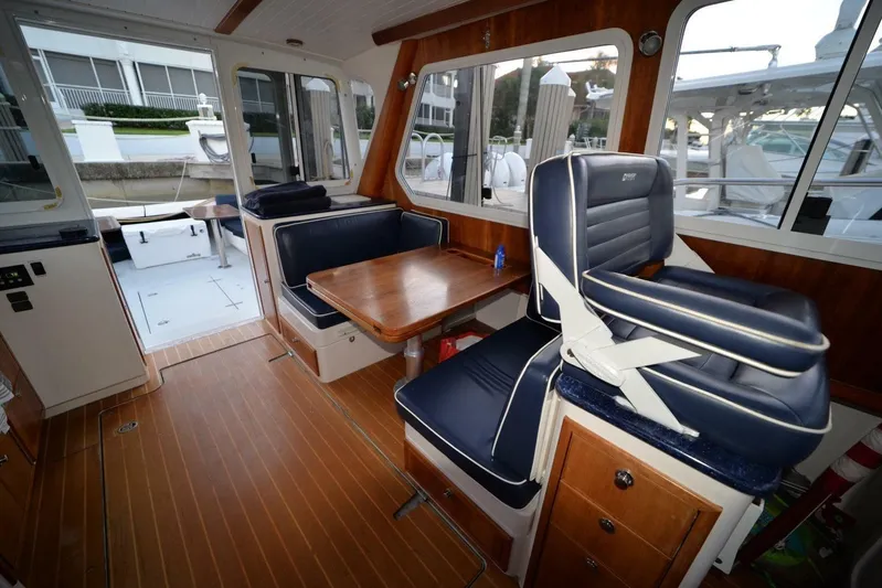 Miracle 2 Yacht Photos Pics Interior of 2006 True North 38 boat with wooden flooring and blue seating.