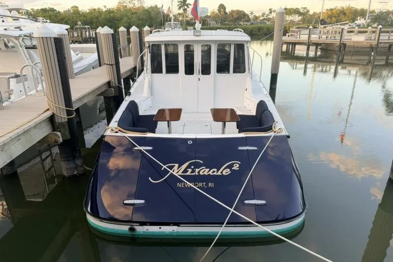 Miracle 2 Yacht Photos Pics 2006 True North 38 boat docked, rear view with seating and tables, Newport, RI.