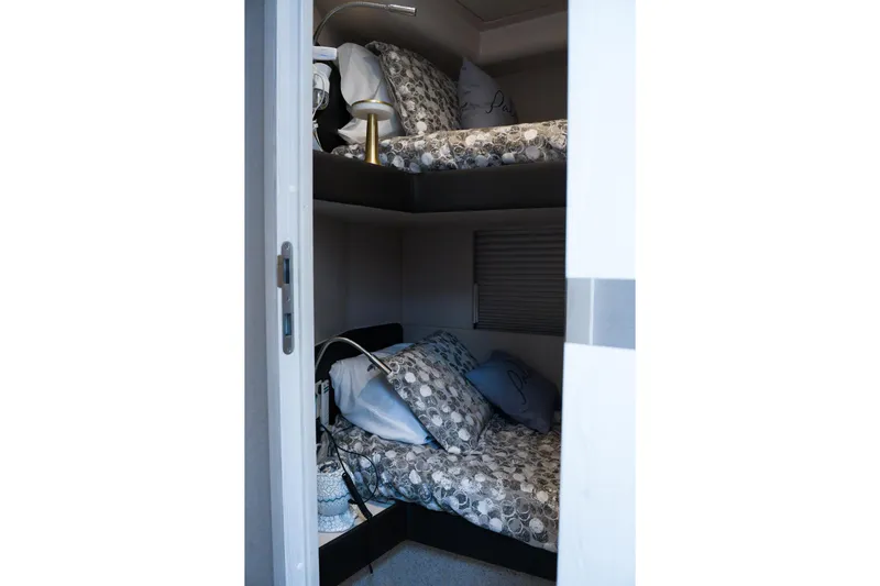 La Paloma Yacht Photos Pics Cozy bunk beds in 2019 Azimut Fly 50 yacht cabin, featuring patterned bedding.