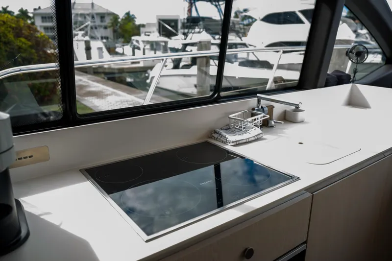La Paloma Yacht Photos Pics Modern kitchen area on 2019 Azimut Fly 50 yacht with sleek stovetop and marina view.