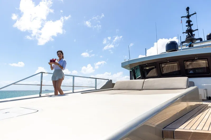 Maverick Yacht Photos Pics Woman on Admiral Impero 40 yacht deck, 2013 model, holding a tray with drinks.