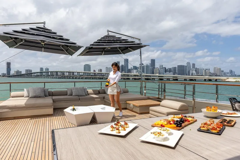 Maverick Yacht Photos Pics Luxury yacht Admiral Impero 40, 2013, with elegant deck setup and city skyline view.