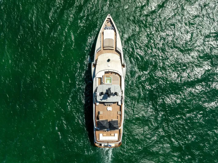 Maverick Yacht Photos Pics Aerial view of 2013 Admiral Impero 40 yacht cruising on green ocean waters.