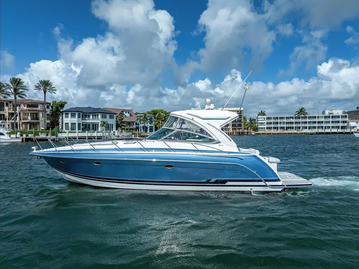  Yacht Photos Pics 2022 Formula 40 PC yacht cruising on a sunny day with waterfront homes in the background.