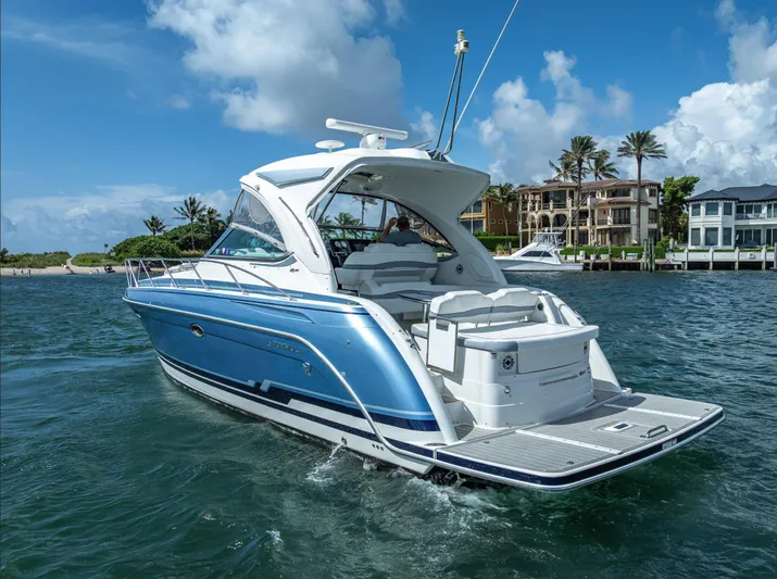  Yacht Photos Pics 2022 Formula 40 PC yacht cruising on a sunny day near luxury waterfront homes.