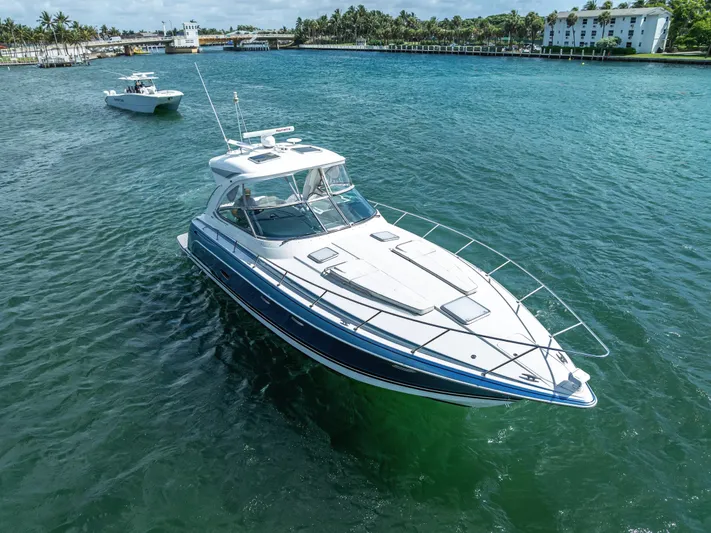  Yacht Photos Pics 2022 Formula 40 PC yacht cruising on clear blue water near a coastal area.