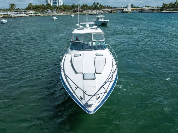  Yacht Photos Pics 2022 Formula 40 PC yacht cruising on a scenic waterway with palm trees in the background.