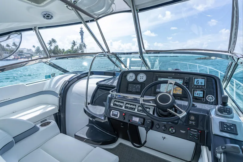  Yacht Photos Pics 2022 Formula 40 PC yacht cockpit with modern navigation system, steering wheel, and ocean view.
