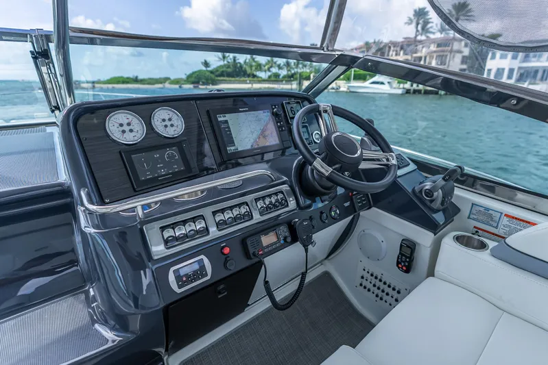  Yacht Photos Pics 2022 Formula 40 PC yacht cockpit with modern navigation and control systems, overlooking serene waters.