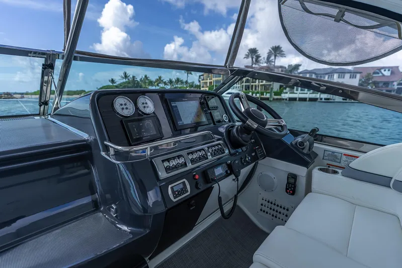  Yacht Photos Pics Helm of 2022 Formula 40 PC yacht with modern controls and scenic waterfront view.