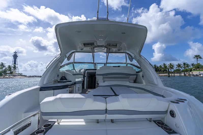  Yacht Photos Pics 2022 Formula 40 PC yacht interior with seating, ocean view, and lighthouse in the background.