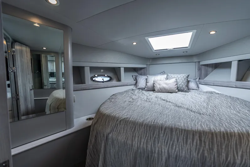  Yacht Photos Pics Luxurious bedroom interior of 2022 Formula 40 PC yacht with elegant bedding and modern design.