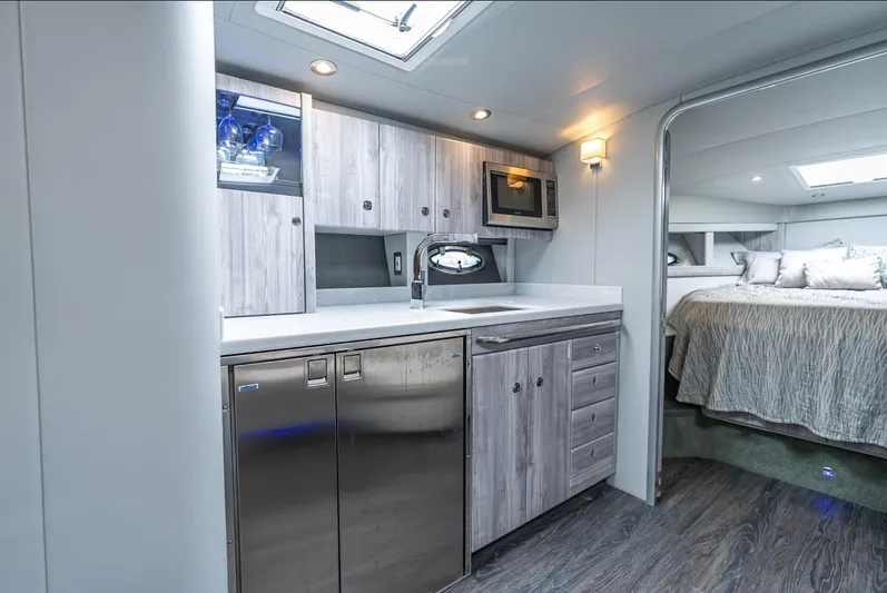  Yacht Photos Pics Modern yacht interior with kitchenette and bedroom, Formula 40 PC, 2022 model.