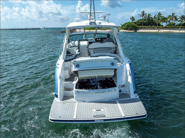  Yacht Photos Pics 2022 Formula 40 PC yacht cruising near tropical shoreline under blue sky.
