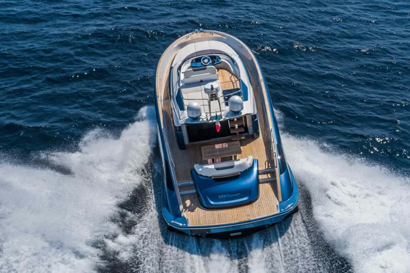  Yacht Photos Pics 2026 Solaris Power 48 Flybridge yacht cruising on open sea, aerial view.