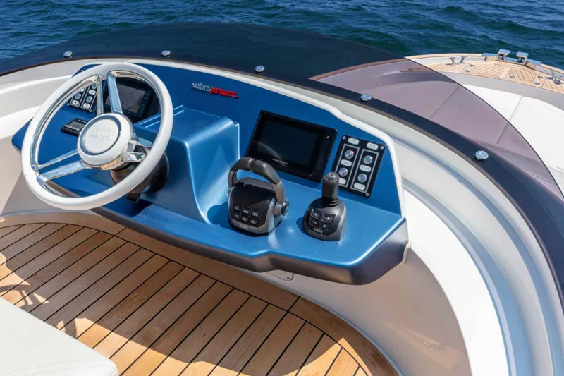  Yacht Photos Pics 2026 Solaris Power 48 Flybridge helm with modern controls and wooden deck, overlooking the ocean.
