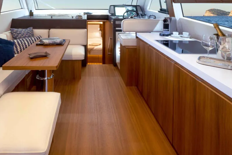  Yacht Photos Pics Luxurious interior of 2026 Solaris Power 48 Flybridge yacht with elegant wood finishes.