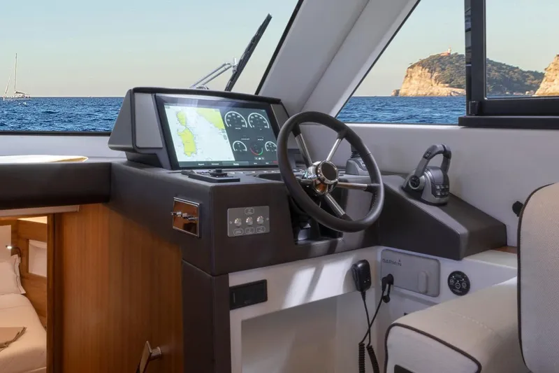  Yacht Photos Pics Helm of 2026 Solaris Power 48 Flybridge yacht with navigation display and ocean view.