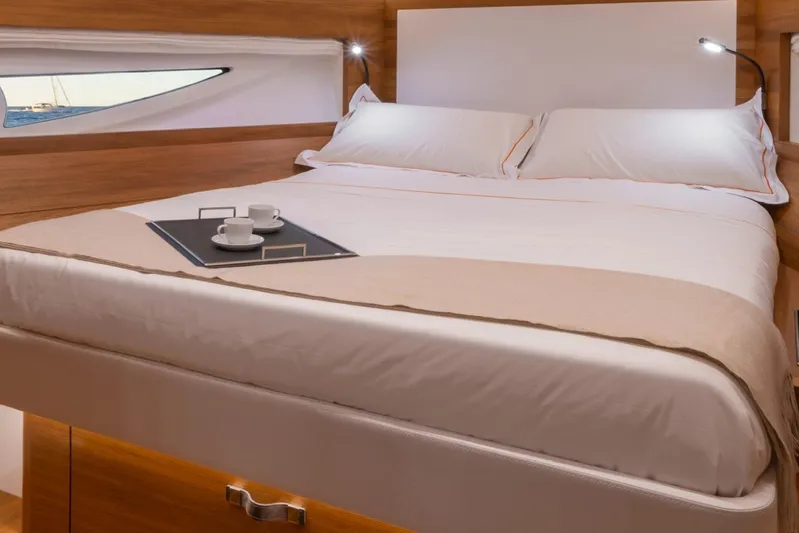  Yacht Photos Pics Luxurious bedroom interior of 2026 Solaris Power 48 Flybridge yacht with elegant bedding.