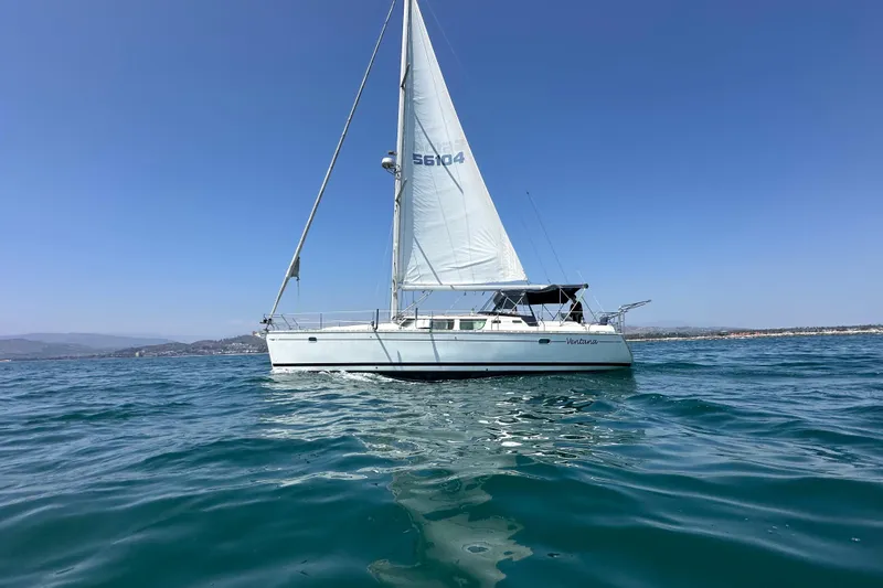  Yacht Photos Pics Jeanneau Sun Odyssey 43 DS sailboat on open water, 2001 model, clear blue sky.