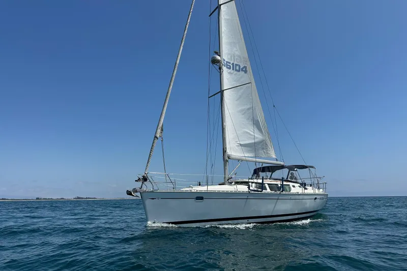  Yacht Photos Pics 2001 Jeanneau Sun Odyssey 43 DS sailing on open water under clear blue sky.