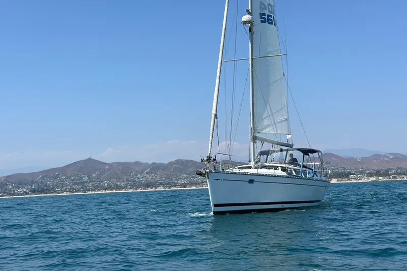  Yacht Photos Pics Jeanneau Sun Odyssey 43 DS sailing near coastal mountains, 2001 model.