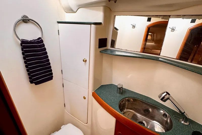  Yacht Photos Pics Bathroom interior of 2001 Jeanneau Sun Odyssey 43 DS yacht, featuring sink and towel.